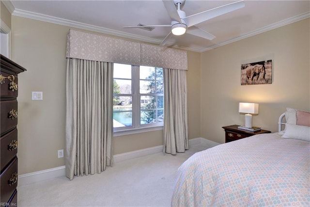 carpeted bedroom featuring baseboards, ornamental molding, and ceiling fan