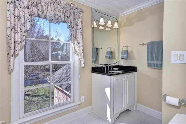bathroom with tile patterned flooring, ornamental molding, baseboards, and vanity