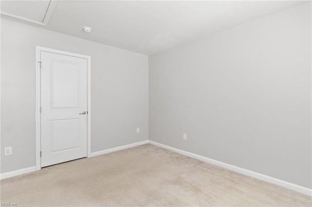 empty room with baseboards and light carpet