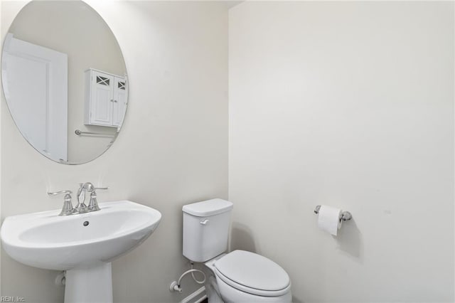 half bath with a sink and toilet