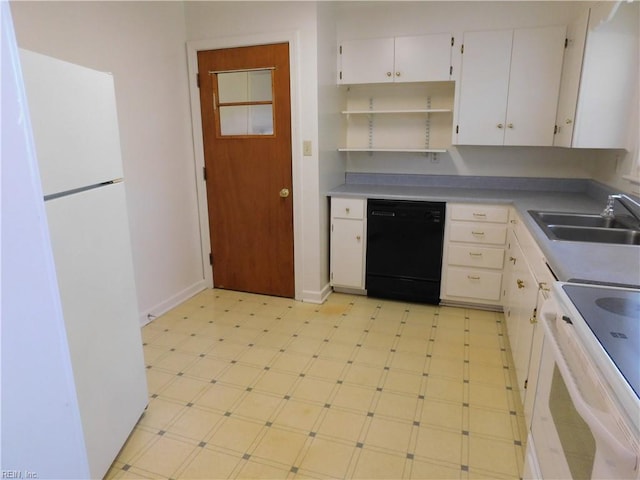 kitchen with a sink, white appliances, white cabinetry, baseboards, and light floors