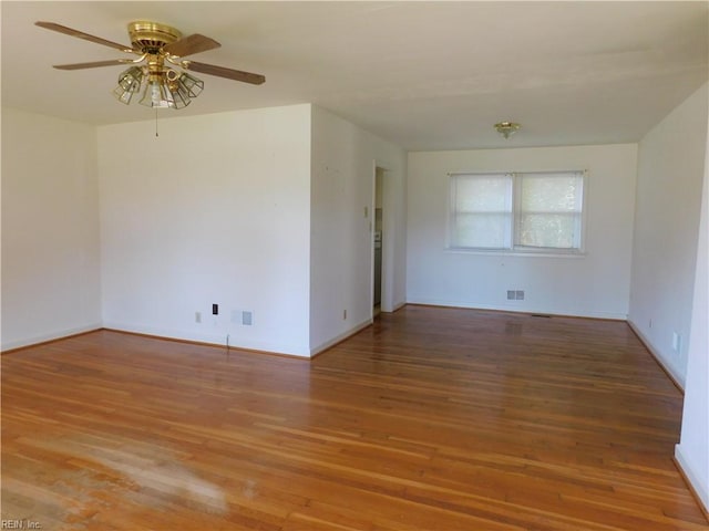 unfurnished room featuring light wood-type flooring, a ceiling fan, and baseboards