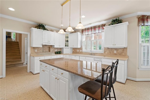 20639 Creekside Dr, Smithfield, VA 23430 - kitchen featuring white cabinets, a breakfast bar, a sink, baseboards, and under cabinet range hood