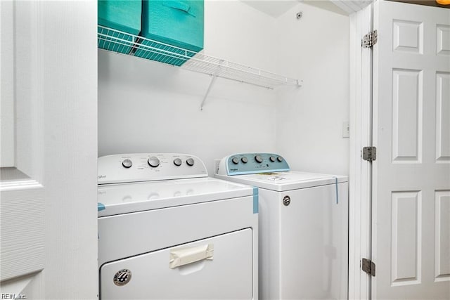 clothes washing area with laundry area and washer and dryer