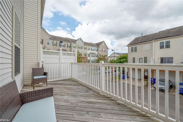 wooden terrace featuring a residential view