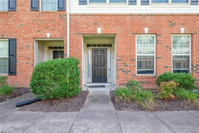 view of exterior entry with brick siding