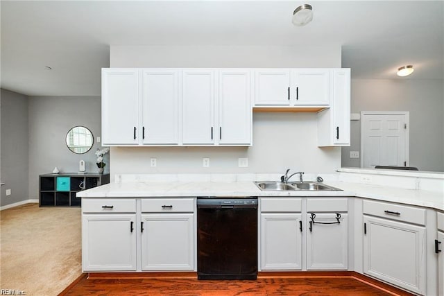 kitchen with white cabinetry, baseboards, a sink, and dishwasher