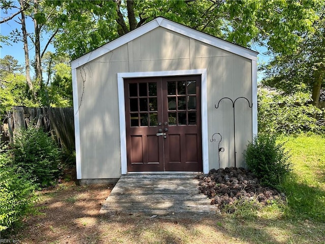 view of outbuilding with fence and an outbuilding