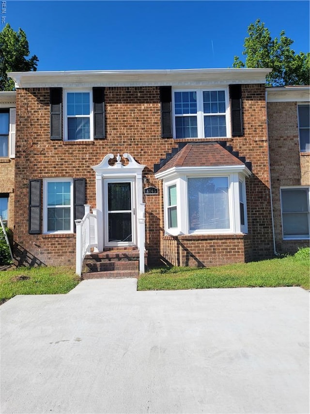 townhome / multi-family property with brick siding