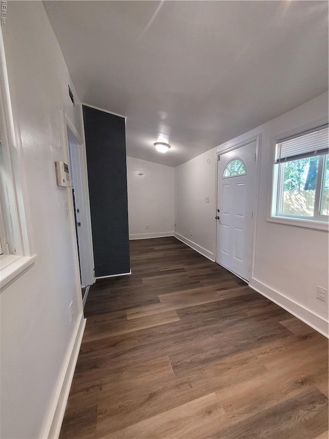 foyer featuring baseboards and wood finished floors