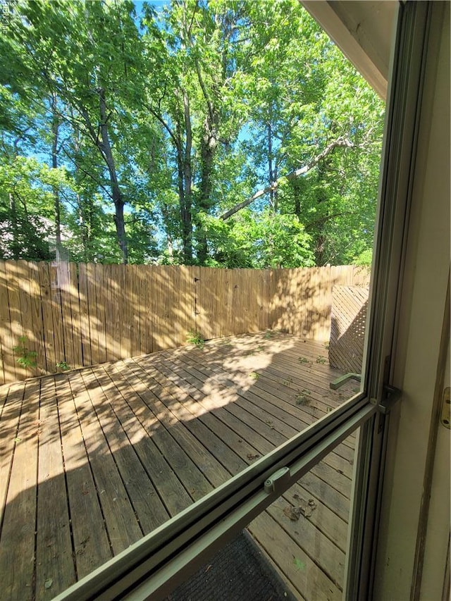wooden terrace featuring fence