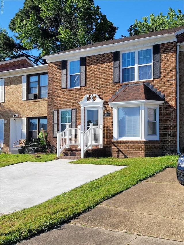 view of property featuring brick siding