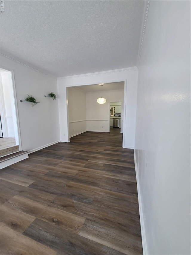 interior space with baseboards, a textured ceiling, and dark wood-style flooring