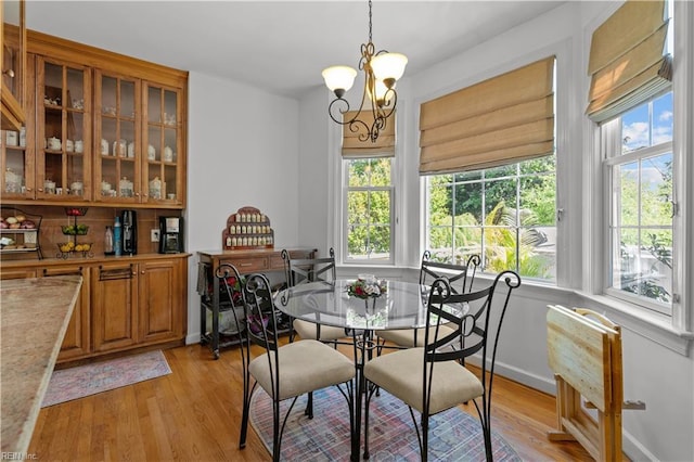 dining room with an inviting chandelier and light wood finished floors