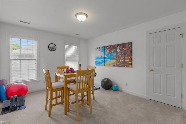 dining space with visible vents, carpet, baseboards, and a healthy amount of sunlight