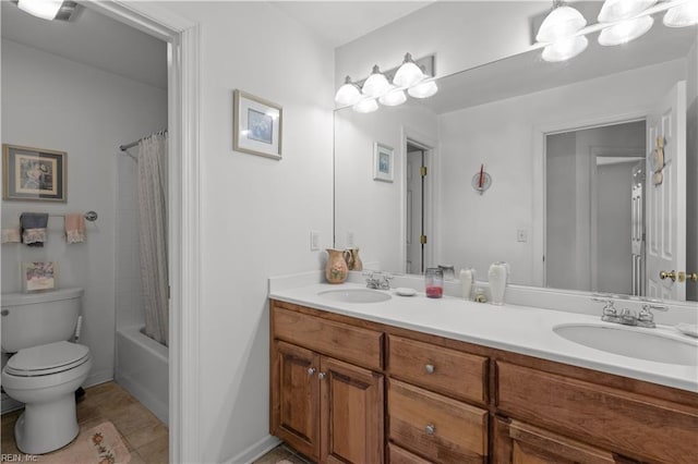 full bath with double vanity, toilet, tile patterned floors, and a sink