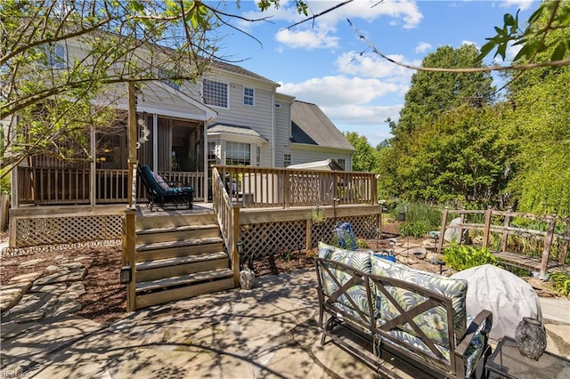 back of house featuring an outdoor living space, a wooden deck, a sunroom, and a patio area