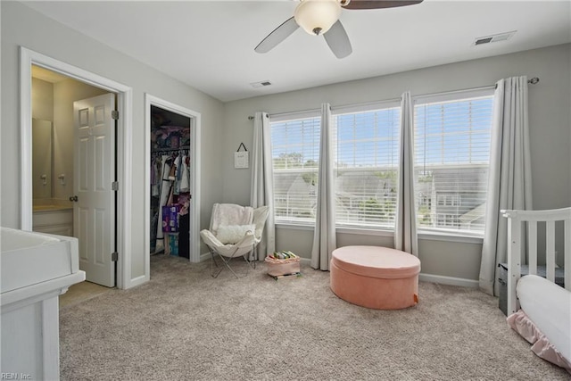 carpeted bedroom with baseboards, visible vents, ensuite bathroom, and a spacious closet