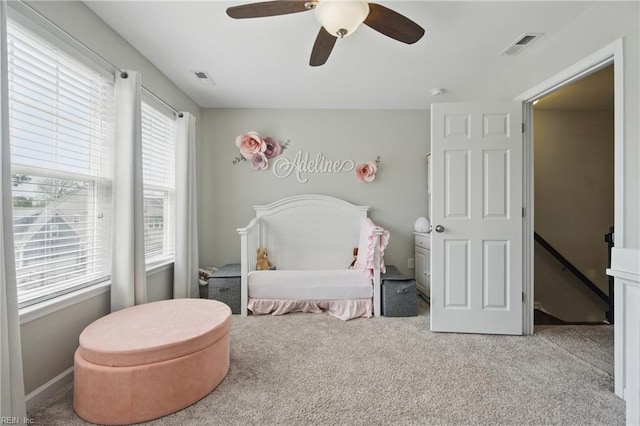bedroom with visible vents, carpet flooring, and a ceiling fan
