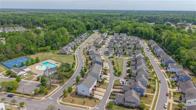 birds eye view of property featuring a view of trees and a residential view