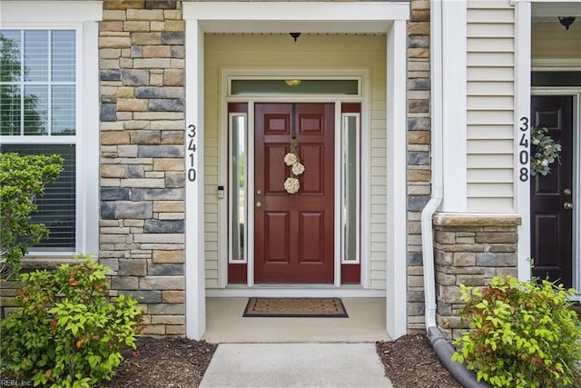 property entrance with stone siding