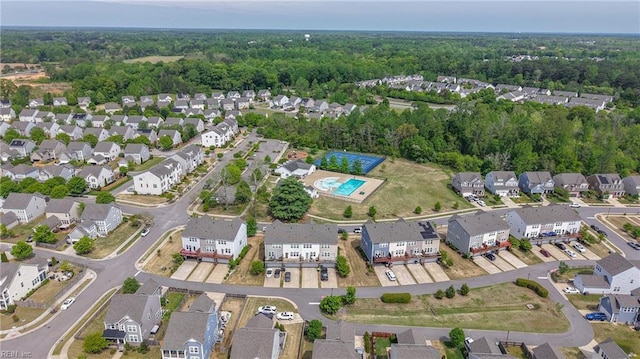 aerial view featuring a wooded view and a residential view