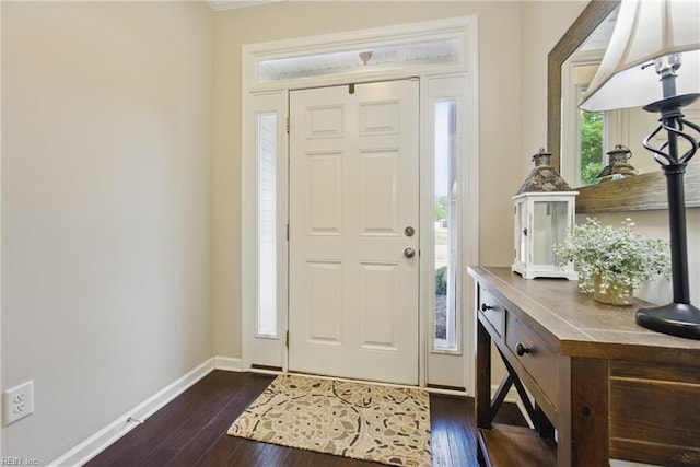 entrance foyer featuring baseboards and dark wood finished floors