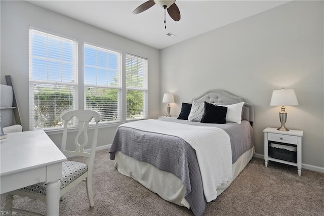 bedroom featuring a ceiling fan, baseboards, visible vents, and light carpet