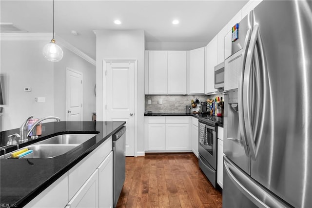 kitchen with stainless steel appliances, white cabinetry, a sink, and dark wood-type flooring
