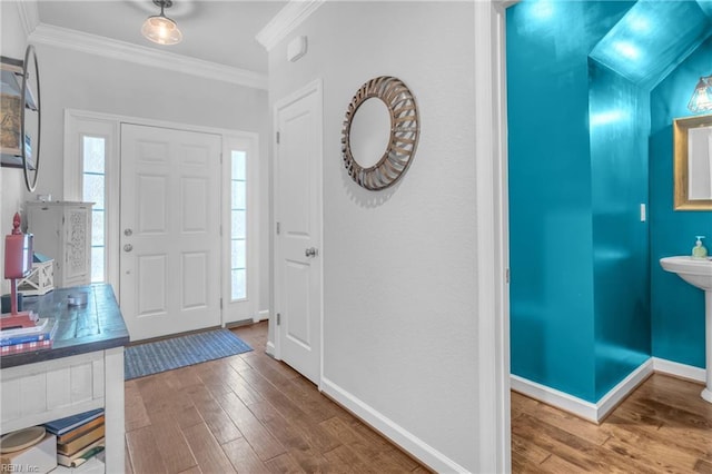 foyer entrance featuring crown molding, a healthy amount of sunlight, and hardwood / wood-style flooring