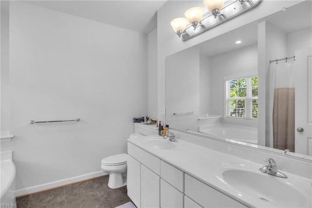 full bath with a sink, toilet, and a tub to relax in