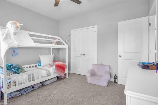 bedroom with a closet, carpet flooring, and a ceiling fan