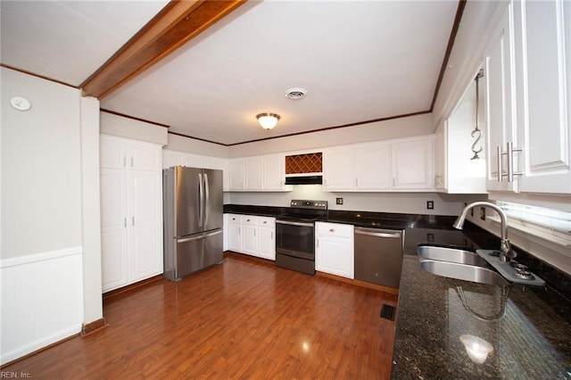 kitchen featuring under cabinet range hood, stainless steel appliances, white cabinets, and a sink