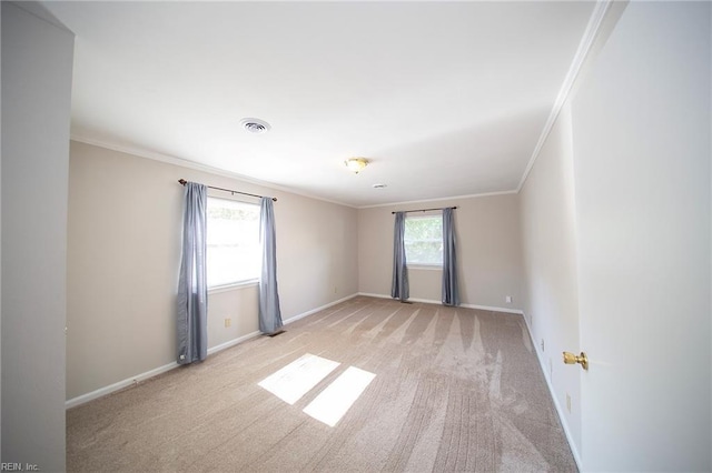 unfurnished room featuring crown molding, baseboards, light colored carpet, and visible vents