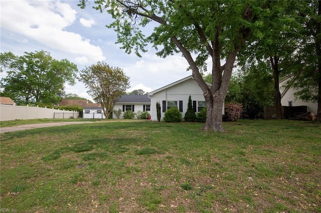 exterior space featuring fence and a front lawn