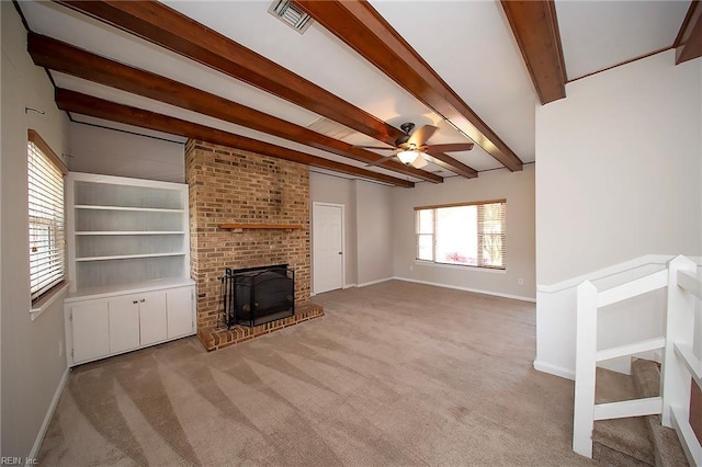 unfurnished living room with a ceiling fan, baseboards, light carpet, and beam ceiling