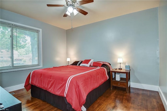 bedroom with baseboards, ceiling fan, and wood finished floors