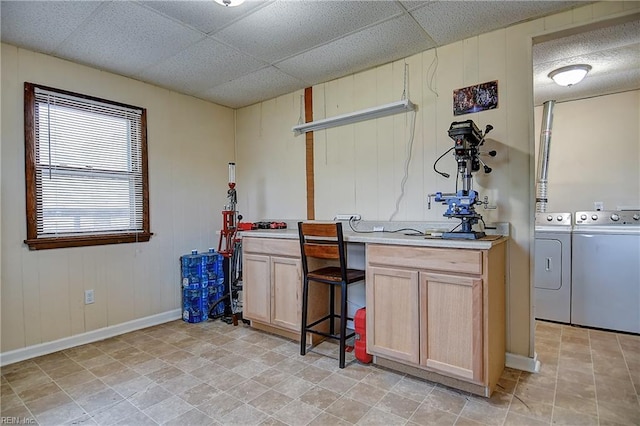 laundry area with washer and dryer and baseboards