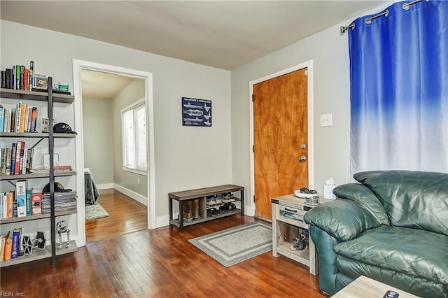 sitting room with wood-type flooring and baseboards