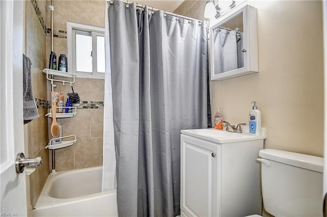 bathroom featuring toilet, shower / bathtub combination with curtain, and vanity
