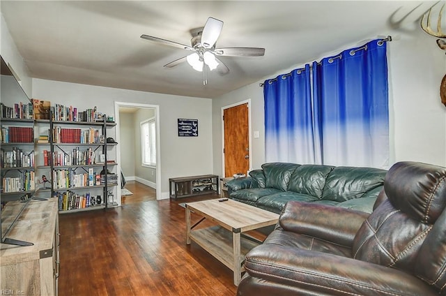 living room with baseboards, a ceiling fan, and wood finished floors
