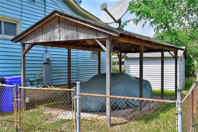 view of parking with a detached carport and fence
