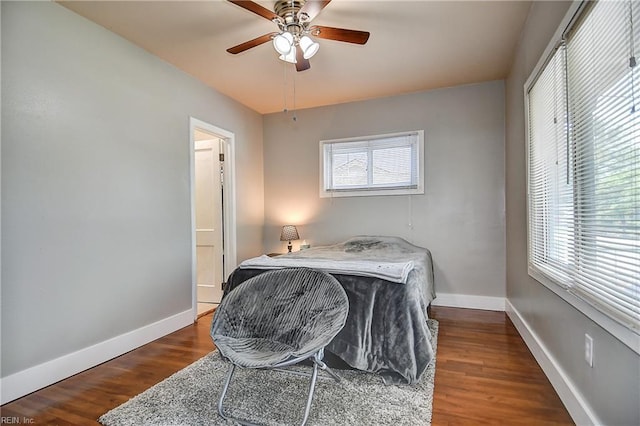 bedroom featuring baseboards, ceiling fan, and wood finished floors