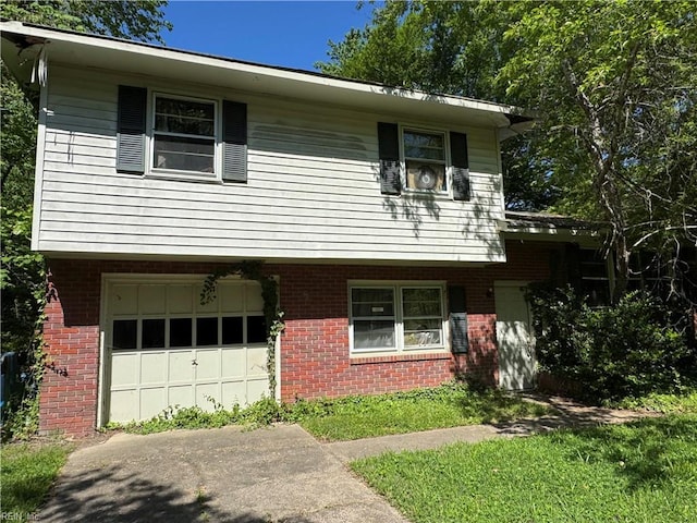 view of front of property featuring brick siding, an attached garage, and driveway