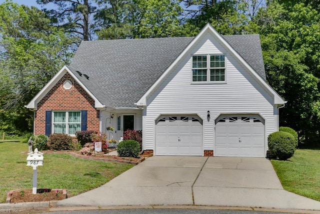 view of front of house featuring brick siding, roof with shingles, a front yard, and concrete driveway