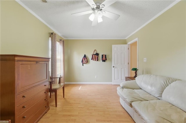 living room with ornamental molding, a textured ceiling, and ceiling fan
