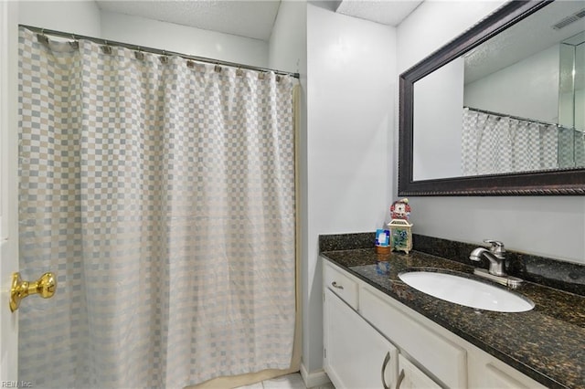 full bath featuring vanity, tile patterned floors, and visible vents