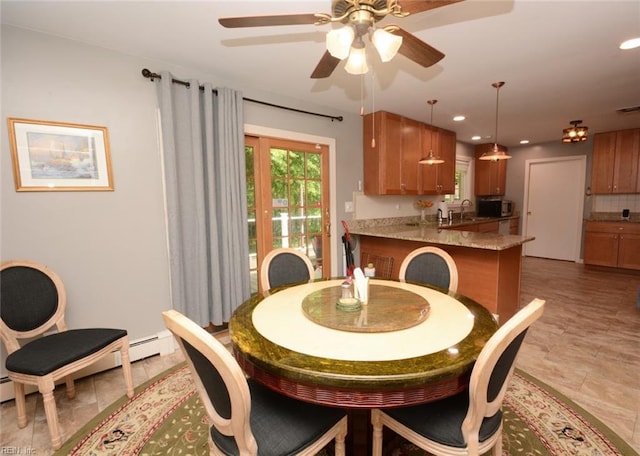 dining area featuring baseboard heating, a ceiling fan, and recessed lighting