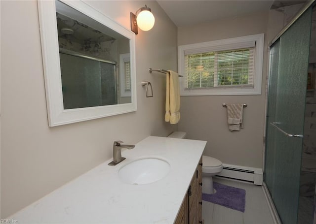 bathroom with vanity, toilet, tile patterned floors, a baseboard radiator, and a stall shower