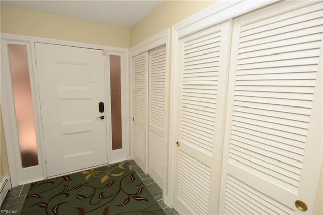 doorway to outside with a baseboard heating unit